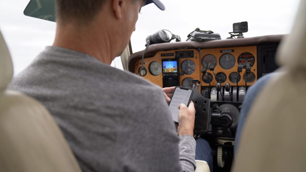 Pilot checking Coflyt app before takeoff