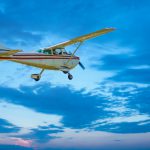 Small prop plane flying at dusk